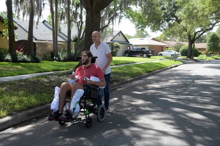 Prichard Colón is taken for a stroll by his father Richard Colon around the neighborhood in Winter Park, Florida, in 2017.
