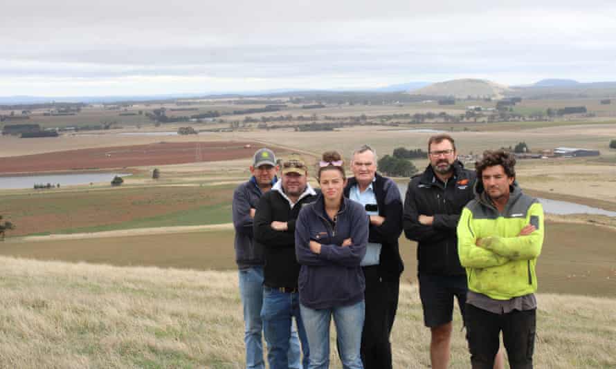 Kain Richardson, Will Elsworth, Joee Aganetti-Fraser, Alistair Vallance, Stuart Vallance and Anthony Fraser, members of the ‘Piss Off AusNet’ group, standing with their arms crossed on a grassy hill in the central highlands