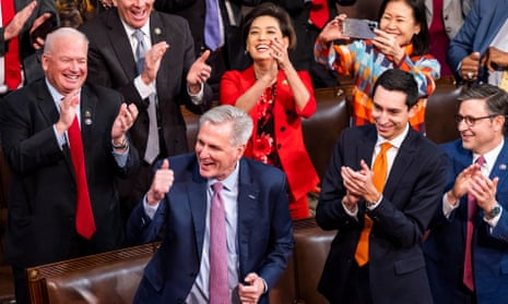 Kevin McCarthy stands among cheering lawmakers, giving a thumbs-up.