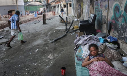 Vanessa, currently homeless, rests on a street where construction of a new Light Rail System has been delayed and partially completed in the Port Zone, on June 17, 2016 in Rio de Janeiro, Brazil.