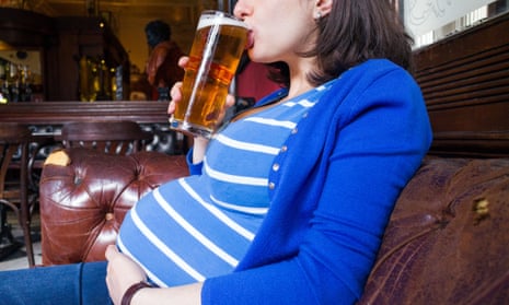 Pregnant woman drinking a pint of beer