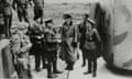 Seven men, some in soldiers' uniforms, watch as Commandant Oberst Schwalm talks to Brigadier Alfred Ernest Snow, surrendering on Alderney on 16 May 1945 next to a metal bunker with an open door