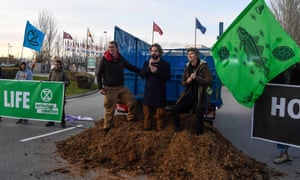 Activists dump manure outside the COP25 climate talks congress in Madrid on Saturday.