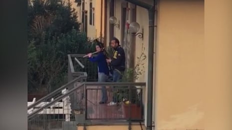 Neighbours play instruments from balconies as Italy stays under coronavirus lockdown – video