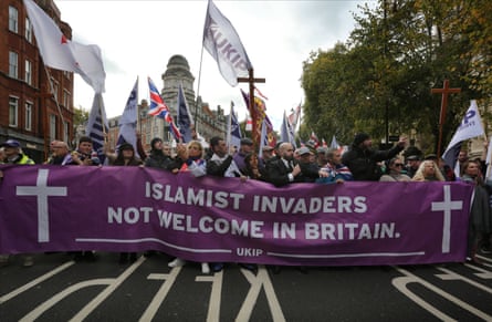 Supporters of Ukip march in London holding a banner saying 'Islamist invaders not welcome in Britain'.