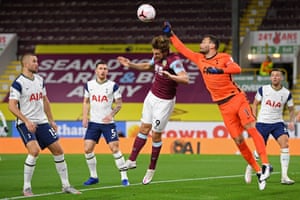 Hugo Lloris punches under pressure from Chris Wood.