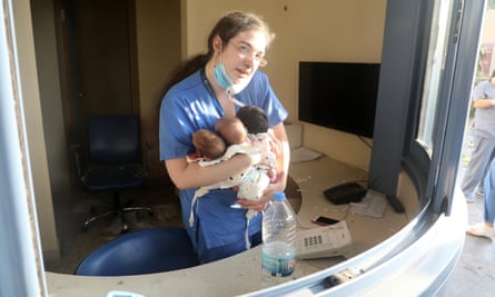 Pamela Zeinoun with the three babies she rescued from the hospital after it was wrecked by the huge explosion in Beirut on 4 August 2020.