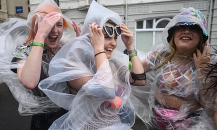 Onlookers brave heavy rain and high winds as they watch the procession during Brighton Pride.