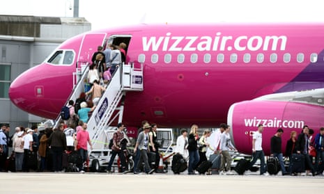 Passengers boarding a pink plane
