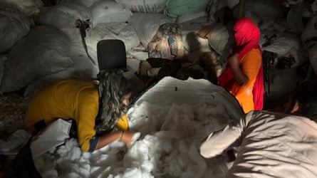 A woman and a man surrounded by material