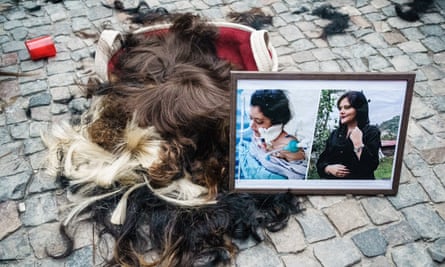 Protesters at a rally in Berlin cut off their hair in solidarity.