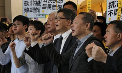 Occupy Central leaders, from right, Benny Tai, Chan Kin-man, Chu Yiu-ming, Tanya Chan and Eason Chung shout slogans before entering a court in Hong Kong.