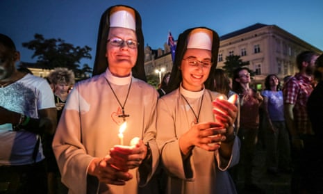 Two pilgrims hold candles at World Youth Day in Krakow, Poland