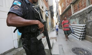 A UPP (Pacifying Police Unit) officer patrols in the Babilonia favela