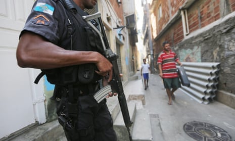 A UPP (Pacifying Police Unit) officer patrols in the Babilonia favela