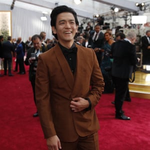 John Cho looks amazing in his caramel-coloured suit with interesting tailoring over a black bow tie and black shirt. It’s all very ‘post traditional suit’ – and we are loving it.