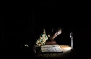 Rita reads aloud from an English textbook at her home in the Volta region of Ghana