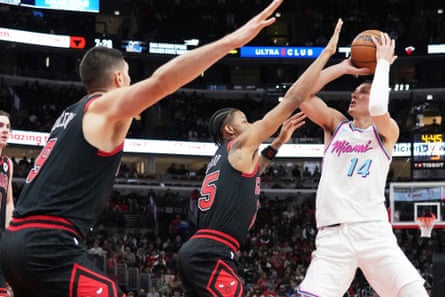 Miami Heat guard Tyler Herro, right, shoots against Chicago Bulls forward Dalen Terry, center, and center Nikola Vucevic during the first half of Wednesday’s game.