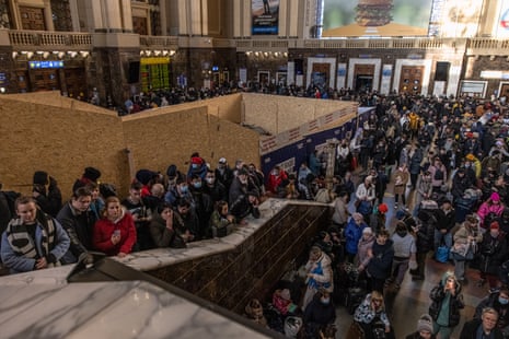 People wait in a hall at Kyiv’s main railway station as they try to flee the Ukrainian capital on 28 February