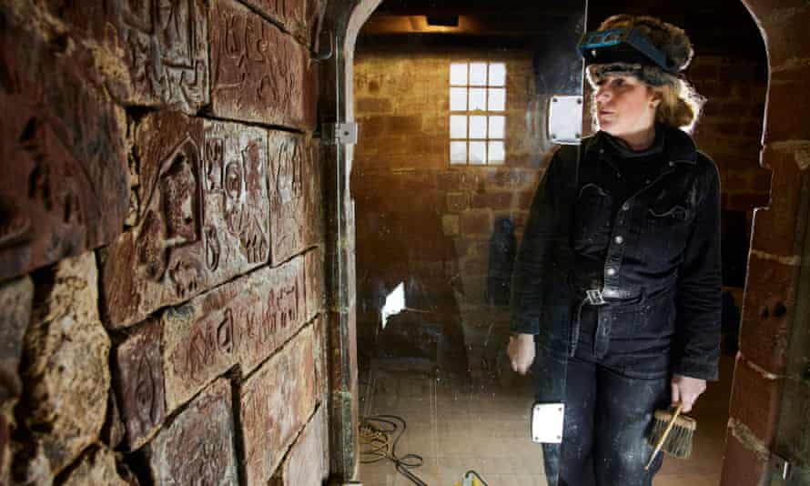 Alex Carrington works on the carvings at Carlisle Castle