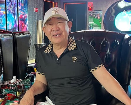 Brother Yuan sitting in a black armchair in the snooker hall