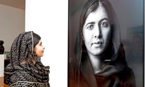 Malala Yousafzai looks at a portrait of herself