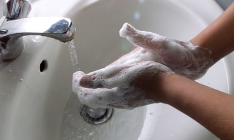 hands washing each other with soap and water