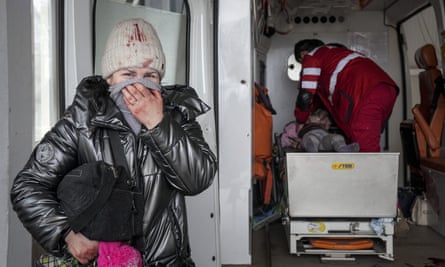 A woman in distress as paramedics perform CPR on a girl who was injured during shelling, at city hospital of Mariupol. 27 February The girl did not survive.