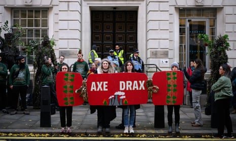 Environmental campaign groups demonstrate outside the Department of Energy Security and Net Zero, as they call for the closure of the Drax power station, on December 02, 2024 in London, England. Climate demonstrators are calling for an end to government subsidies for the Drax Power Plant in North Yorkshire, which generates electricity by burning wood pellets sourced from trees in North America. (Photo by Leon Neal/Getty Images)