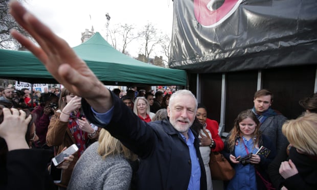 The Labour leader, Jeremy Corbyn, waves to supporters at the rally in support of the NHS in London.