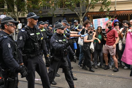Police release OC spray on protesters gathered for a transgender rights rally, involving opposing neo-Nazi protesters, outside Parliament House in Melbourne