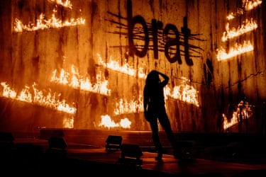 Charli XCX in front of a burning Brat flag at Glastonbury Festival