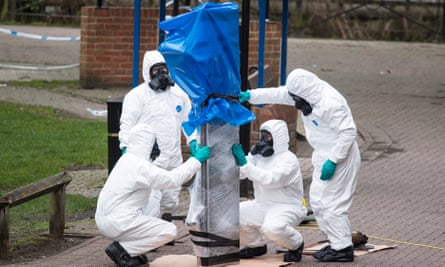 Forensics officers remove the bench where the former Russian spy Sergei Skripal and his daughter were found in Salisbury, England