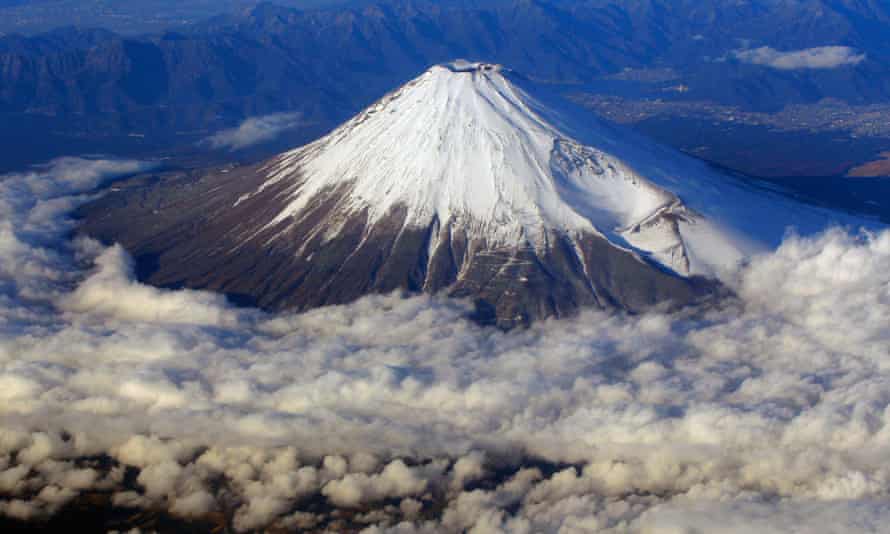 Snow-covered Mount Fuji, Japan’s highest peak at 3,776-meter seen from an airplane window.
