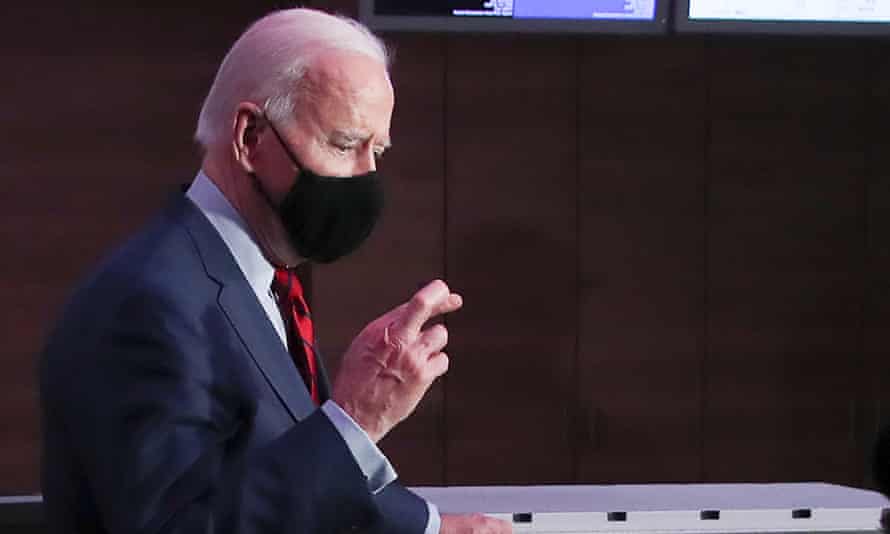 Joe Biden crosses his fingers in response to a reporter’s question on gun reform laws the day after a mass shooting in Boulder, Colorado.