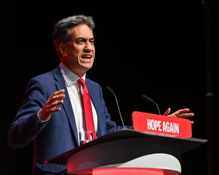 Ed Miliband speaks at the conference, looking very animated with his hands raised.