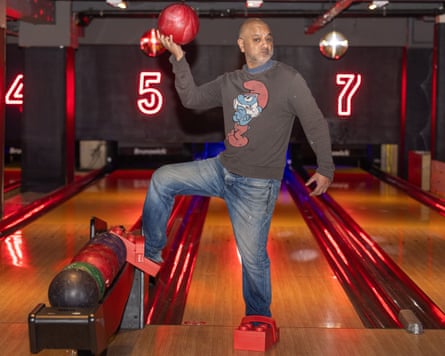 Rich Pelley in his Lego Crocs posing with a ball at a bowling lane