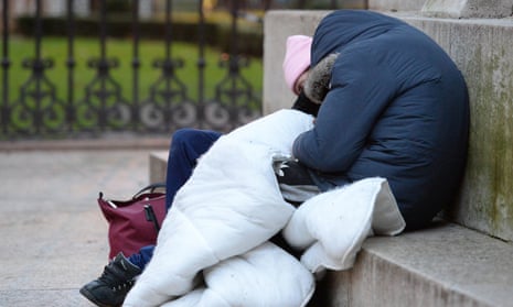 Two people with blanket sleeping rough