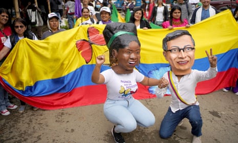 People wearing masks depicting Colombia's president Gustavo Petro and vice president Francia Marquez wait for the arrival of Marquez for her symbolic inauguration ceremony in her hometown, in Suarez, Colombia August 13, 2022