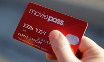 hand holding a red card that says moviepass