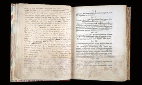 A page from Principia Mathematica, right, with Newton’s notes opposite, held at Cambridge University. A European first edition has sold for £3m.
