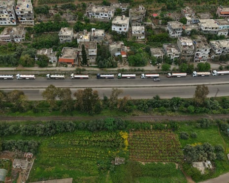 A line of Iraqi diesel-laden tanker trucks lined up along the Tartus-Baniyas highway as they wait to unload their cargo at the Baniyas port refinery in Syria