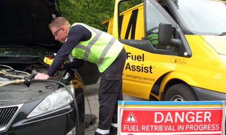 A car filled with the wrong type of fuel is drained by an AA Fuel Assist technician. More than five times as many people as usual have put the wrong fuel in their car during the recent crisis.