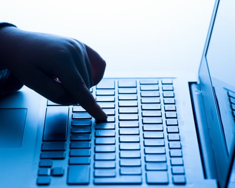 A hand typing on a laptop keybord.