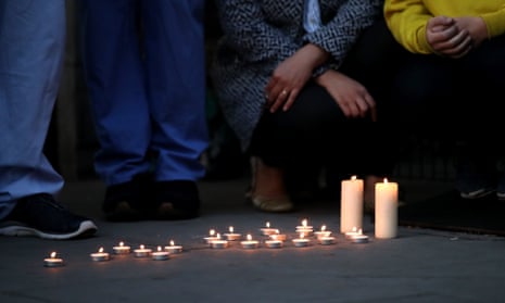 NHS workers lay down candles in memory of a colleague at Newham University hospital, the area with the highest mortality rate.