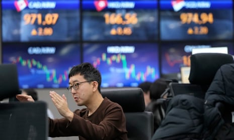 A currency trader gestures at the foreign exchange dealing room of the KEB Hana Bank headquarters in Seoul, South Korea, today.