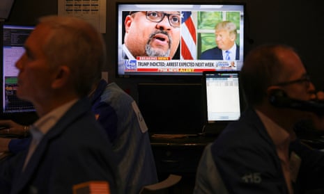 Former U.S. President Donald Trump indicted by a Manhattan grand jury, in New York CityA screen shows New York District Attorney Alvin Bragg and former U.S. President Donald Trump after Trump’s indictment by a Manhattan grand jury following a probe into hush money paid to porn star Stormy Daniels, as traders work on the trading floor of the New York Stock Exchange (NYSE), in New York City, U.S., March 31, 2023.