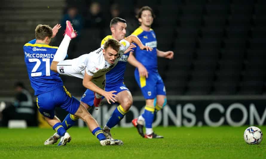 MK Dons' Scott Twine tries to break through the AFC Wimbledon defense in January.