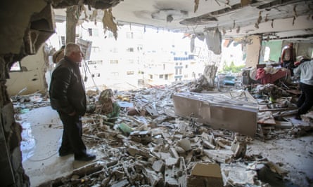 Palestinians inspect a heavily damaged building in Gaza City in the aftermath of the Israeli strikes