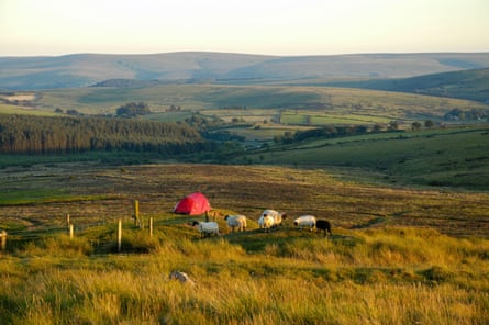 An orange tent on an isolated, rugged moor